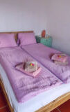 a bed with a pink blanket